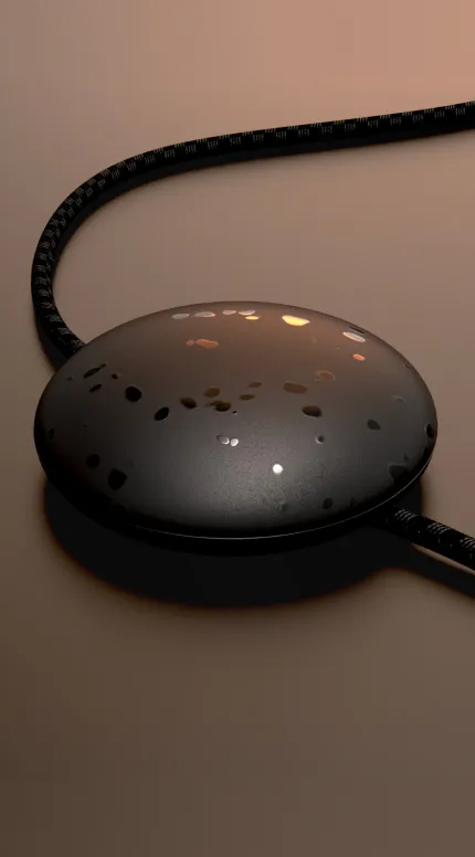 CAD render: a dark dome-shaped device with a braided cable